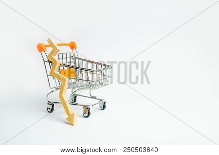 A Supermarket Cart And A Wooden Arrow Down On A White Background. The Concept Of The Fall Of Prasada