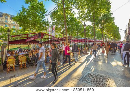 Paris, France - July 2, 2017: Tourists Walk On The Most Famous Avenue Of Paris, The Champs Elysees, 