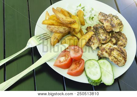 Salad Of Vegetables, Grilled Meat On A White Plate On A Black Background, Photo Menu