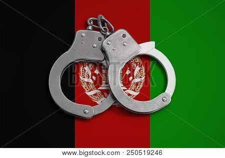 Afghanistan Flag And Police Handcuffs. The Concept Of Observance Of The Law In The Country And Prote