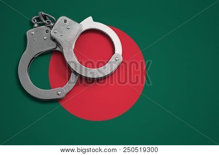 Bangladesh Flag  And Police Handcuffs. The Concept Of Crime And Offenses In The Country.