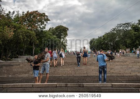 Odessa, Ukraine - August 13, 2015: Potemkin Stairs With People Posing With Eagles On Them. The Odess