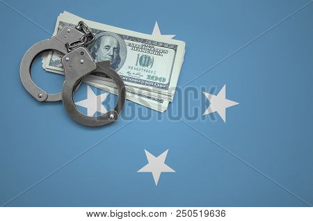 Micronesia Flag  With Handcuffs And A Bundle Of Dollars. The Concept Of Breaking The Law And Thieves