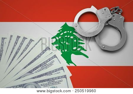 Lebanon Flag  With Handcuffs And A Bundle Of Dollars. The Concept Of Illegal Banking Operations In U