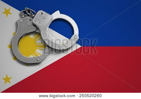 Philippines Flag  And Police Handcuffs. The Concept Of Crime And Offenses In The Country.