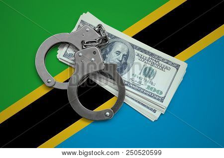 Tanzania Flag  With Handcuffs And A Bundle Of Dollars. Currency Corruption In The Country. Financial