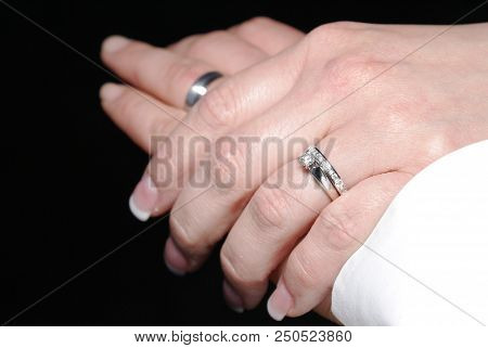 Newly Wed Couple Showing Their Hands With Rigns,