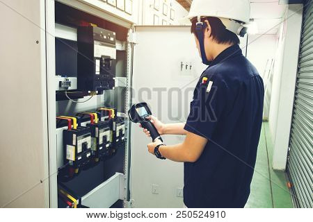 Technician Use Thermal Imaging Camera To Check Temperature In Factory