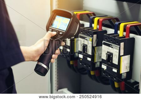 Technician Use Thermal Imaging Camera To Check Temperature In Factory