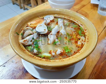 Thai Food Style,closeup Of Chicken Feet Spicy Soup With Tomato, Mushroom, Chilli And Coriander In Ye