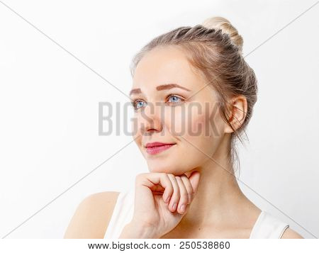 Pretty Young Girl With Make-up Props Up Chin And Looks Away In Studio, Close Up Portrait