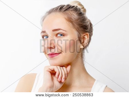 Pretty Young Girl With Make-up Props Up Chin In Studio, Close Up Portrait