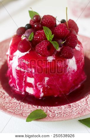 Ice Cream Cake With Berry Topping, Fresh Berries And Mint On A Light Background. Selective Focus.