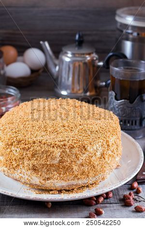 Sweet Home Layered Honey Cake On A Wooden Table With Nuts. 