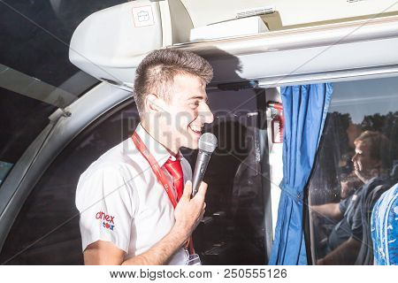 Marmaris, Turkey - May 19, 2018: Male Tour Guide With A Microphone In The Bus In Evening Time