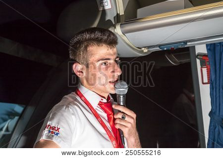 Marmaris, Turkey - May 19, 2018: Male Tour Guide With A Microphone In The Bus In Evening Time
