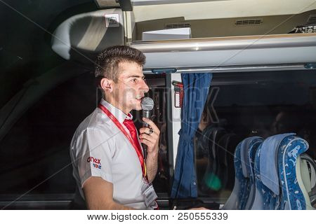 Marmaris, Turkey - May 19, 2018: Male Tour Guide With A Microphone In The Bus In Evening Time