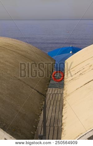 Colors At Sea With Bathing Hut Beach Umbrella And Lifejacket