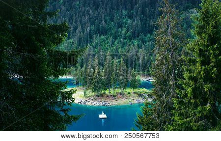 Caumasee Lake With A Small Island Located In The Middle Of The Crystal Clean Lake, Near Flims, Switz