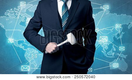 Businessman holding tool with global map graphic on the background