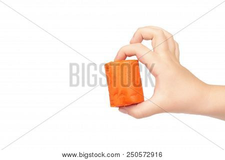 Orange Plasticine Bar With Kid Hand, Isolated On White Background. Copy Space Template.