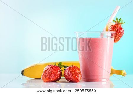 Fresh Tasty Strawberry Smoothie In Glass Cup With Drinking Straw On Azure Background. Strawberries A