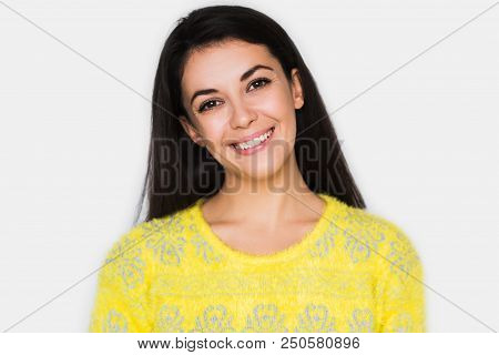 Portrait Of Brunette Cheerful Woman With Healthy Toothy Smile, Look In Front With Hands On Hair. You
