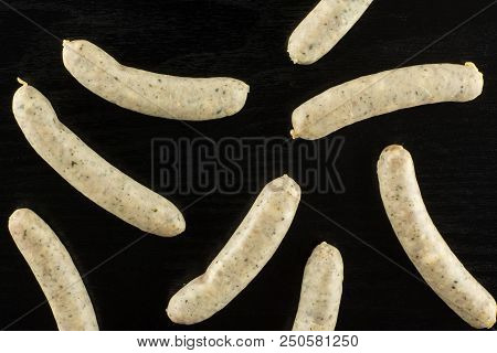 Lot Of Whole Bavarian White Sausage Flatlay On Black Wood
