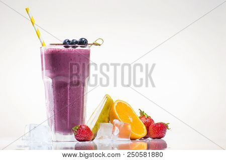 Delicious Smoothie With Drinking Straw In High Ball. Strawberries And Sliced Orange Near The High Ba