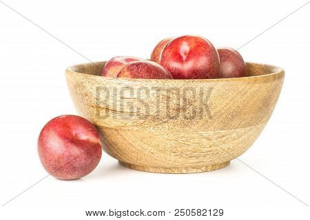 Lot Of Whole Fresh Pluot Interspecific Plums Variety In A Wooden Bowl Isolated On White