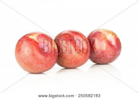Group Of Three Whole Fresh Pluot Interspecific Plums Variety In A Row Isolated On White