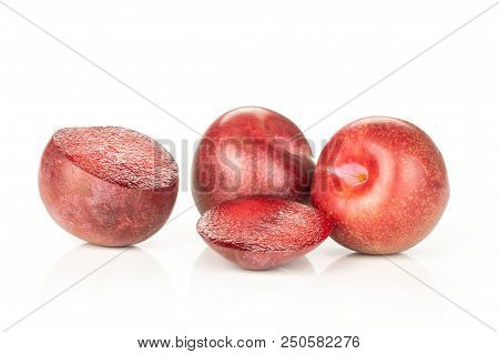 Group Of Two Whole Two Halves Of Fresh Pluot Interspecific Plums Variety Isolated On White