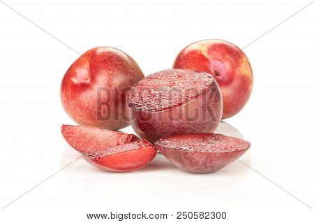 Group Of Two Whole One Half Three Slices Of Fresh Pluot Interspecific Plums Variety Isolated On Whit