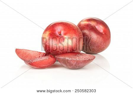 Group Of Two Whole Three Slices Of Fresh Pluot Interspecific Plums Variety Isolated On White
