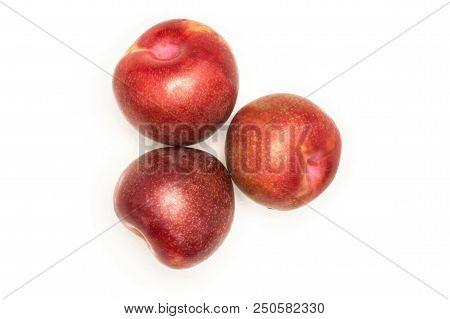 Group Of Three Whole Fresh Pluot Interspecific Plums Variety Flatlay Isolated On White