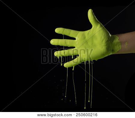 Elegant Male Hand On A Light Paint Isolated On A Black Background.