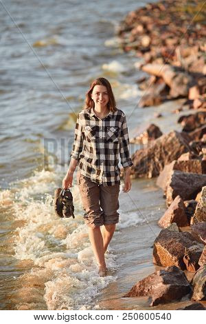 Young Woman Walking Along Great Salt Lake Beach. Landscape With People And Copy Space.