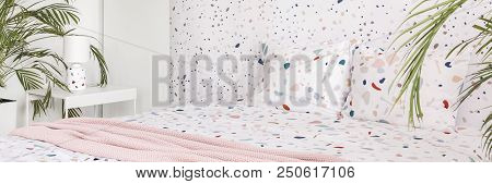 Real Photo Of Lastrico Bright Bedroom Interior With Fresh Plants, Double Bed And Lamp On Metal Bedsi