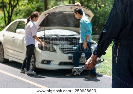 Car Mechanic Ready For Work. Auto Mechanic With Large Wrench In Hands On Morning Outdoor