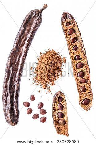 Carob pods and carob powder on the white background.