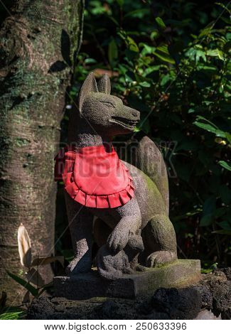 Tokyo, Japan - October 29: Kitsune Statuette Near A Shinto Shrine. A Supernatural Fox In Old Japanee