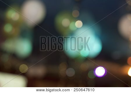 Many Blurred Small Electric Bulbs. A Blurry Photo Of The City