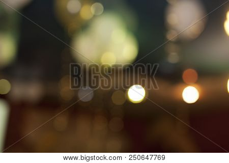 Many Blurred Small Electric Bulbs. A Blurry Photo Of The City