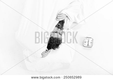 Guy Hides Face Under Blanket. Morning And Wake Up Concept. Man With Beard Yawning And Wants To Stay 
