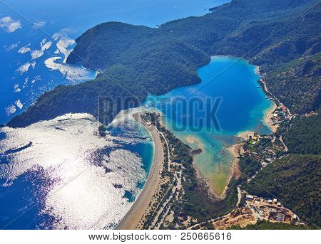 Amazing Aerial View Of Blue Lagoon In Oludeniz, Turkey. Summer Landscape With Sea Spit, Green Trees,