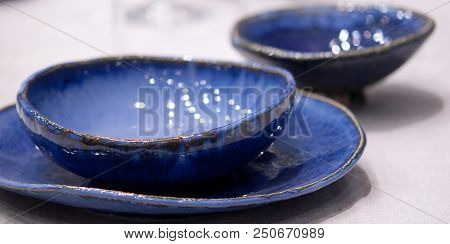 Blue Porcelain Plates And Bowls On The Table