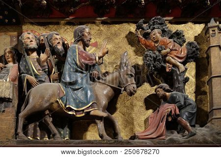 PARIS, FRANCE - JANUARY 04, 2018: Intricately carved and painted frieze inside Notre Dame Cathedral depicting Jesus' triumphal entry into Jerusalem, Palm Sunday, UNESCO World Heritage Site in Paris.