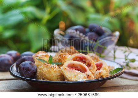 Plum Dumplings Coverder With Breadcrumb And Sprinkled With Sugar. Homemade Dessert With Dough And Pl