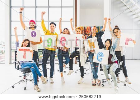 Multiethnic Diverse Group Office Coworker Or Creative People Hold Word Together, Cheer And Celebrate