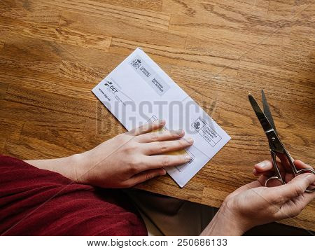 Paris, France - Jul 1, 2018: Woman Opening Envelope From Spanish Authorities From The Direcion Gener